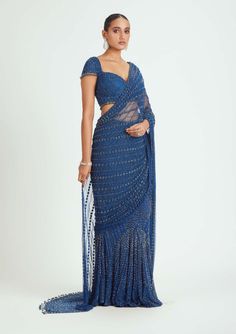 Elevate your style with our cobalt blue net pre-draped sari, adorned with tonal beadwork, sequins, and crystals. This sari is a captivating choice for special events and celebrations, offering a glamorous and elegant look without the hassle of draping. Make a bold fashion statement in this stunning ensemble. Festive Blue Pre-draped Saree For Evening, Blue Draped Blouse Piece For Evening, Blue Draped Lehenga For Reception, Festive Blue Wedding Pre-draped Saree, Blue Draped Pre-draped Saree For Evening, Blue Draped Fitted Choli, Fitted Draped Blue Choli, Blue Fitted Draped Choli, Fitted Blue Pre-draped Saree For Festive Occasions