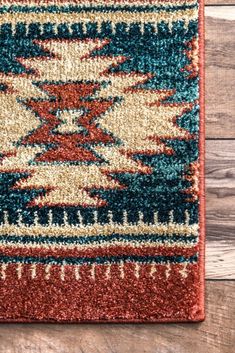 a red and blue area rug sitting on top of a wooden floor