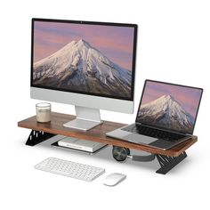 two computers are sitting on a desk with a keyboard and mouse