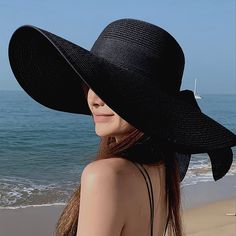 This Wide-Brim Floppy Black Straw Hat Is Perfect For Summer. It's Meticulously Crafted To Provide Shade And Style During Sunny Days, Making It A Popular Choice For Beach Outings And Other Outdoor Activities. The Wide Brim Helps Protect Your Face And Neck From The Sun, While The Floppy Design Gives It A Relaxed And Casual Look. The Black Color Is Versatile And Can Easily Match With Various Outfits, Making It A Practical Choice For Summer Accessorizing. The Bow Trim Band Adds A Touch Of Femininity Black Flat Brim Hat With Uv Protection, Black Brimmed Boater Hat For Beach, Black Fedora Hats For Beach Season, Black Fedora Straw Hat For Vacation, Black Fedora For Beach Season, Black Fedora Hat With Uv Protection, Black Flat Brim Sun Hat For Summer, Black Fedora With Uv Protection, Adjustable Black Summer Boater Hat