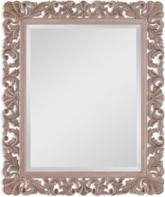 an ornate wooden frame mirror on a white wall with a light brown border around it