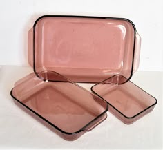 three pink dishes sitting on top of each other