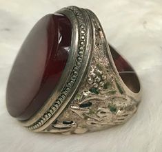 This ring is an estate sale find A stunning statement piece! It is not Marked but I had a Jeweler test it and he confirmed it is silver There is a beautiful oval large carnelian stone The silver is Embossed with birds and flowers on one side and what appears to be an arrow on the other. The ring Weighs  17 grams  with the Stone The size is about 10 1/4 I offer free shipping in the United States  all sales are final Chunky Ring, An Arrow, Carnelian Stone, Birds And Flowers, Estate Sale Finds, Chunky Rings, Ring Vintage, Rings Statement, Estate Sale