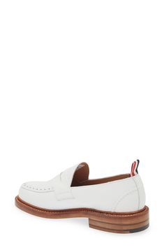 A tricolor grosgrain pull loop brings the label's signature flair to this calfskin-leather loafer detailed with classic broguing at the apron toe. Leather upper and lining/leather and synthetic sole Made in the UK Designer Shoes White Brogue Dress Shoes For Work, Classic White Wingtip Tassel Loafers, White Tassel Loafers With Brogue Detailing For Formal Occasions, White Plain Toe Loafers For Work, Classic White Leather Work Shoes, White Leather Shoes With Brogue Detailing For Work, White Brogue Leather Shoes For Work, Classic White Leather Shoes For Work, Classic Slip-on Dress Shoes With Contrast Sole