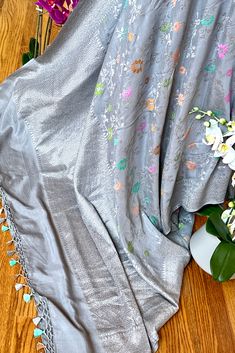 This exquisite tussar georgette silk saree in steel grey color is nothing but a saree lovers dream. The soft flowing textured tussar georgette silk has a beautiful drape. This saree is nothing but a handcrafted luxury! Approximate Length 6.25 - 6.50 mtrs (inclusive of blouse length)Approximate Height - 46 - 50” Saree comes with fall, picot and tassels done when applicable . Blouse piece is cut. Approximate weight - 1.3 lbs Kindly Note : The colors you see on your device may vary due to the color reproduction, brightness and resolution of individual devices. If you'd like more clarity before your purchase, please contact our support team. Silk Cotton Sarees, Beautiful Drapes, Blouse Length, Blouse Piece, Cotton Saree, Silk Blouse, Silk Sarees, Gray Color, Weaving