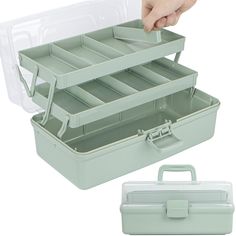 a person is holding two trays with dividers on each side, and one has a plastic lid