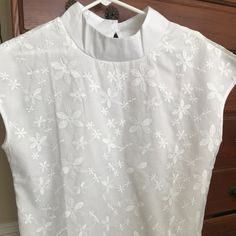 Never Worn White Blouse. Embroidery Front And Back. Normal Length. Size L But Fits More Like A Generous M. Elegant Crew Neck Top With Floral Embroidery, Elegant Floral Embroidered Crew Neck Top, White Embroidered Top With Collar, Spring Short Sleeve Blouse With Chikankari Embroidery, Spring Chikankari Embroidered Short Sleeve Blouse, Summer White Blouse With Tonal Embroidery, Elegant White Embroidered Short Sleeve Top, Fitted White Top With Machine Embroidery, White Fitted Top With Machine Embroidery