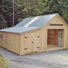 a large wooden garage sitting in the middle of a forest