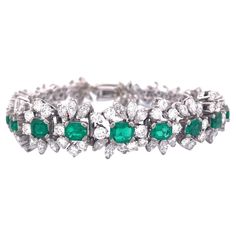 Indulge in the allure of our stunning 18K white gold bracelet, adorned with a captivating arrangement of emeralds and diamonds. The focal point of this elegant piece is the brilliant 4-carat emerald, flanked by four emeralds cascading in size from large to small on both sides.Surrounding these vibrant emeralds are meticulously set 16 carats of diamonds, showcasing a combination of round and marquise cuts. The bracelet's total weight of 35 grams signifies its substantial craftsmanship and luxurious feel. Selling Price: $ 23000.00 Elevate your style with this remarkable bracelet, a true embodiment of timeless beauty and sophistication. White Gold Bracelet, Diamond Jewellery, Marquise Cut, Emerald Diamond, Timeless Beauty, Diamond Bracelet, Gold Bracelet, Jewelry Bracelets, Emerald