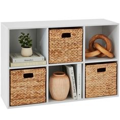 four wicker baskets are stacked on top of each other in this white shelf unit