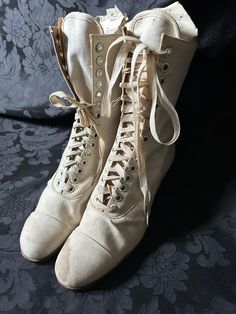 Original white/cream canvas Edwardian boots. Either new/old stock or barely worn. Some water staining, one original bootlace (short)  and one replacement bootlace. Manufacturer- Bedggood Manufacture of boots & shoes Premier (code 3E 575) Quite wearable, good solid condition. Measurements- 10 inches outside heel - toe, 2 inch heel, 3 inches widest width of sole, 9 inch height to top, 8 inch narrowest point at ankle (not inc lacing width), 9 inch leg. Eyelets 14 up (28 in total) These boots would White Riding Boots, Beige Boots With Laces And Round Toe, Vintage White Boots With Round Toe, Vintage White Round Toe Boots, Vintage White Lace-up Boots, White Lace-up Vintage Boots, Vintage Beige Almond Toe Boots, Vintage Beige Closed Toe Boots, 1800s Shoes