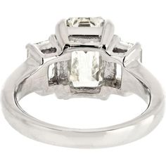 Relish in the sophistication of fine artistry and avant-garde design with our breathtaking 3 Carat Emerald Cut Diamond Three Stone Engagement Ring. This exquisite piece exudes timeless elegance and modern allure, making it a perfect choice for discerning individuals seeking a symbol of everlasting love and commitment.Crafted with precision, the centerpiece of this ring features a mesmerizing 3.15-carat emerald-cut diamond, certified by GIA with a J color grade and VS1 clarity, ensuring exceptional quality and brilliance. Flanking this stunning center stone are two equally mesmerizing emerald-cut diamonds totaling 1.15 carats, adding a captivating symmetry and luxurious appeal to the design.Encased in lustrous platinum, this ring boasts a substantial metal weight of 9.1 grams, reflecting it Elegant Sterling Silver Emerald Ring With Round Cut, Elegant Emerald Ring For Anniversary, Elegant Diamond Emerald Ring For Formal Occasions, Elegant Emerald Diamond Ring For Formal Events, Luxury Polished Diamond Promise Ring, Modern Gia Certified Emerald Ring Gift, Elegant Formal Emerald Diamond Ring, Luxury Rings With Polished Finish For Promise, White Diamond Jewelry With Timeless Design