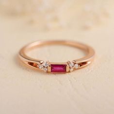 Dainty Ruby Ring-Emerald Cut Ruby Ring-Stackable Ring-Sterling Silver Ring-Promise Ring-14k Solid Gold Wedding Ring-July Birthstone Ring About Ring:- Gemstone = Ruby (lab) Gemstone Shape = Baguette  Gemstone Cut - Emerald Cut ------------------------------------------------------------------------------------------------------------------------------------------------- Fast Shipping: It will take 1-8 business days to send out your item Material: 24k/20k/18k/14k/10k/9k Yellow Gold or Sterling Sil Classic Rose Gold Birthstone Ring For Formal Occasions, Classic Rose Gold Ruby Ring For Anniversary, Classic Rose Gold Ruby Promise Ring, Formal Rose Gold Ruby Ring With Round Band, Classic Rose Gold Ruby Ring, Classic Rose Gold Diamond Ruby Ring, Classic Rose Gold Ruby Ring With Diamond, Simple Rings, Baguette Engagement Ring