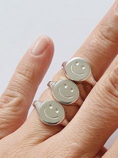 "\"Smile , it's contagious ! Let's pass it on :) \" *Good vibes Only ! These smiley signet rings are hand carved in wax and cast in silver with the lost wax technique . A perfect and timeless reminder for you or your loved ones . *Available in Sterling Silver ,Gold Vermeil ,Rose Gold Vermeil and in SOLID YELLOW GOLD 9K . * SHINY or MATTE finish . *Need it fast ? You can upgrade shipping with FedEx here : https://www.etsy.com/listing/966774899/fedex-tnt-express-shipping-delivery?ref=shop_home_act Novelty Smiley Face Jewelry As Gift, Novelty Smiley Face Jewelry For Gifting, Novelty Smiley Face Jewelry For Gifts, Novelty Smiley Face Jewelry Gift, Smiley Face Ring As Gift, Lost Wax Casting Rings, Lost Wax Casting Jewelry, Hand Carved Ring, Art Clay Silver