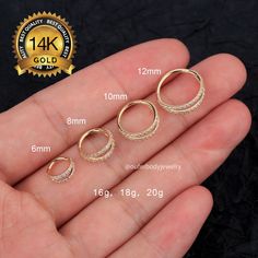 three pairs of gold plated sterling silver hoop earrings with czrs on each side