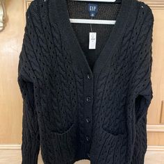 Nwt. 95% Polyester, 5% Wool. Cable Knit Front And Sleeves, Shaker Knit Back. 2 Front Patch Pockets. Black Cable Knit Cardigan For Layering, Gap V-neck Fall Sweater, Black Cable Knit Casual Cardigan, Gap Long Sleeve Cardigan For Layering, Casual Black Cable Knit Cardigan, Casual Gap Winter Cardigan, Casual Winter Cardigan By Gap, Casual Black Open Knit Cardigan, Casual Open Knit Sweater For Work