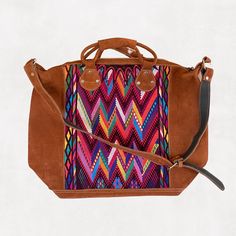 Our eco-friendly weekender bag is made with a stunning repurposed handwoven huipil (Guatemalan blouse) exterior with a black cotton lining. One exterior and one interior pocket plus an adjustable suede shoulder strap.It is a stylish way to pack for a quick weekend get-away. Product Dimensions: 25.5" W x 17" H x 8" D. Double handles measures approx 20" with 2" drop.adjustable suede shoulder strap. Handwoven Crossbody Hobo Bag For Travel, Travel Woven Satchel, Woven Hobo Shoulder Bag For Travel, Brown Bohemian Weekender Shoulder Bag, Traditional Tote Weekender Bag For Everyday Use, Travel Hobo Shoulder Bag With Woven Details, Bohemian Leather Tote Duffle Bag, Artisan Handwoven Satchel For Travel, Bohemian Shoulder Bag With Leather Trim For Everyday Use