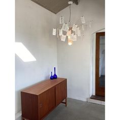 a blue vase sitting on top of a wooden cabinet