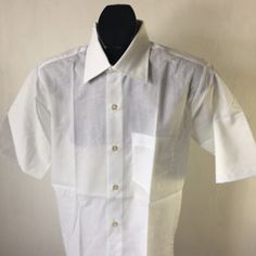 "vintage men's 70s dress shirt,  3 1/4\" spread collar,  chest pocket,  shirt tail hem.   LABEL -   ABRAHAM & STRAUS men's store   PERMANENT PRESS           MADE in USA         65% polyester / 35% combed cotton    snow white  color   CONDITION - NEW-OLD-STOCK,    EXCELLENT          SIZE 14 1/2   (small)      chest (measured flat across ) 21\" across back shoulders 16 1/2\" sleeve length  short  length (back neck to hem) 30\"" Formal Short Sleeve Tops With Pockets, Fitted Short Sleeve Dress Shirt For Summer, Fitted Short Sleeve Summer Dress Shirt, Classic Short Sleeve Shirt With Lapel Collar, Fitted Short Sleeve Dress Shirt With Button Closure, Formal Shirt With Pockets And Lapel Collar, Fitted Business Shirt With Pockets, Collared Dress Shirt With Placket For Summer, Fitted Short Sleeve Shirt With Welt Pockets