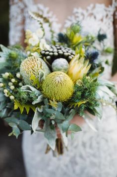 a bride holding a bouquet of flowers in her hands