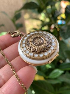 For yourself or someone you love...💕 The sunflower moves itself in the most direct position in front of the sun so it can get the maximum sun rays. This is symbolic of spiritual faith, and worship because we follow our belief system as the sunflower moves to face the life-giving rays of the sun. NOTE: this locket doesn't have photo frames. You can add glue to insert the two photos. ADDING PHOTOS: The option to add photo/photos means that I will be the one who will resize, crop, print, and inser Bronze Flower-shaped Jewelry Gift, Vintage Gold Jewelry With Sunflower Design, Vintage Birth Flower Necklace For Wedding, White Round Locket Necklace For Anniversary, Round White Locket Necklace For Anniversary, Antique Medallion Jewelry For Mother's Day, Handmade Adjustable Antique Locket Necklace, Handmade Antique Adjustable Locket Necklace, Vintage Antique Gold Jewelry As A Gift