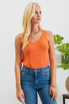 Our Lightweight Sweater Tank is the perfect staple piece for your wardrobe, providing a lightweight and versatile option for both summer and year-round wear. Also available in other colors. Lightweight, knit tank top Fits true to size 55% acrylic, 45% nylon Machine wash gentle cycle, hang dry Orange V-neck Knit Top, Summer Textured Knit Tank Top For Layering, Casual Stretch Sweater Vest, Casual Stretch Tank Sweater Vest, Orange Knit V-neck Top, Trendy Tank Knit Top For Layering, Spring Knit Tank Top, Trendy Tank Sweater Vest For Summer, Casual Textured Knit Tank Top For Fall