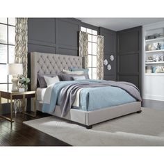 a bedroom with gray walls and white carpeting, including a bed in the center