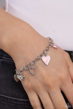 A textured silver heart silhouette, sleek silver heart, sunburst-detailed silver heart, red-painted heart, and baby pink pearl heart dangle along a silver chain for a romantic declaration. Features an adjustable clasp closure around the wrist. Sold as one individual bracelet. Trendy Metal Heart Bracelet For Valentine's Day, Trendy Metal Jewelry For Valentine's Day, Valentine's Day Metal Charm Bracelet With Heart Beads, Valentine's Day Silver Heart Bracelet, Pink Heart Pendant Metal Jewelry, Adjustable Pink Stainless Steel Charm Bracelet, Adjustable Heart-shaped Metal Charm Bracelet, Silver Double Heart Charm Bracelet For Valentine's Day, Pink Heart Pendant Jewelry