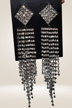 Rhinestone Chain Tassel Long Chandelier Drop Earrings Wear these earrings to make a statement. These Chandelier Drop Earrings are perfect for any occasion, whether it be a wedding, date night, or party. They are designed in an elegant chandelier style that cascades beautifully to look great with any dress style. The earrings are made with high-quality rhinestones and metal material that will give you years of wear and tons of compliments. Zinc Alloy Material Fairy Pattern Gold And Silver Detail Crystal Chandelier Earrings With Rhinestone Fringe, Glamorous Crystal Dangle Tassel Earrings, Glamorous Rhinestone Dangle Chandelier Earrings, Crystal Chandelier Dangle Earrings For Glamorous Events, Glamorous Metal Tassel Earrings For Party, Glamorous Dangle Chandelier Earrings, Silver Rhinestone Fringe Tassel Earrings For Party, Elegant Silver Tassel Earrings For Party, Glamorous Crystal Chandelier Earrings With Bling