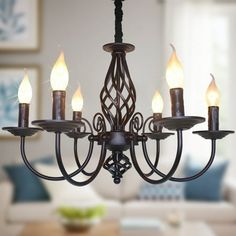 a chandelier with lit candles hanging from it