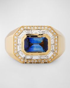 an 18k yellow gold ring set with blue and white stones, surrounded by diamonds