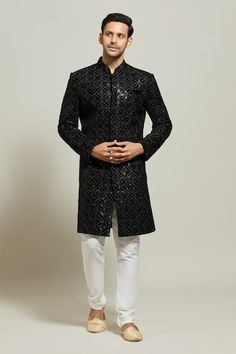 Black sherwani featuring geometric floral pattern in thread and sequin work. Paired with a white churidar. - Aza Fashions Formal Kurta With Mirror Work For Festive Occasions, Formal Kurta With Mirror Work For Diwali, Formal Mirror Work Kurta For Diwali, Formal Festive Kurta With Mirror Work, Transitional Bandhgala With Mirror Work For Party, Fitted Bandhgala With Chikankari Embroidery For Festive Occasions, Festive Fitted Bandhgala With Chikankari Embroidery, Eid Party Bandhgala With Chikankari Embroidery, Transitional Party Bandhgala With Mirror Work