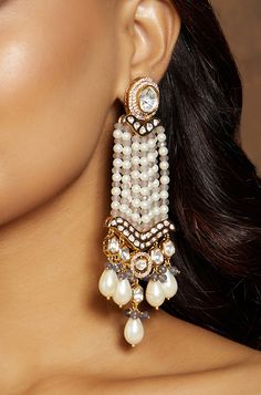 Multi Colour Classic Long Earrings - Joules By Radhika This multi colour designer chandelier earring in gold tone is an amalgamation of multi kundan polkis, white pearls & grey & blue agates. Ideal to be worn on festive, wedding & party occassions on your Indian & fusion attire.Every artistic piece from Joules by Radhika is made with real semi precious stones only, giving it a regal look & feel. SET INCLUDES: Earrings Details: Handcrafted with ❤️ Metal: Brass Product Type: Earrings Stone: Pearls Cheap Traditional Multicolor Earrings, Luxury Multicolor Meenakari Earrings, Luxury Multicolor Temple Jewelry Earrings, Luxury Festive Meenakari Pearl Earrings, Luxury Multicolor Earrings For Diwali, White Fusion Danglers With Latkans, White Chandelier Earrings With Stone Work For Celebrations, White Fusion Style Chandbalis For Diwali, Fusion Style White Bridal Earrings With Latkans