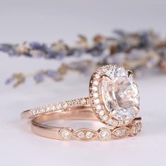 an oval cut engagement ring with side stones on the band, surrounded by lavender flowers