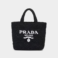 Prada raffia tote bag with woven monogram across front  Flat top handles  Open top  Approx. 9.4"H x 9.4"W x 3.1"D Made in Italy Prada Raffia Tote Bag, Rafia Bag, Prada Raffia, Raffia Tote Bag, Prada Tote Bag, Embroidered Tote Bag, Embroidered Tote, Straw Tote Bag, Straw Handbags