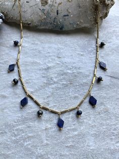 Lapis lazuli beads,  brass chain,  wire, and clasp. The necklace measures 14-16" long. ~Visit our new shop Free Spirit Rox for beautiful collectible crystals, gemstones, and mineral specimens! https://www.etsy.com/shop/FreeSpiritRox Gold Beaded Necklaces With Gemstone Dangle, Gold Dangle Beaded Necklace With Gemstone Beads, Gold Lapis Lazuli Spiritual Necklace, Gold Dangle Beaded Necklace With Gemstones, Brass Necklaces With Round Natural Stone Beads, Brass Round Beads Necklace With Natural Stones, Brass Necklace With Round Natural Stone Beads, Gold Spiritual Necklace With Dangling Beads, Spiritual Gold Necklace With Dangling Beads