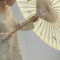 a woman holding an umbrella in her hand