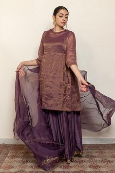 Aubergine kurta with embroidered floral and half moon motifs. Comes with an inner, matching gharara and an organza silk dupatta.
Components: 4
Pattern: Embroidered
Type Of Work: Thread, Sequin
Neckline: Round
Sleeve Type: Three quarter
Fabric: Kurta: Chanderi Tissue, Gharara: Cotton Silk, Dupatta: Organza silk, Lining: Cotton
Color: Purple
Other Details: 
Straight silhouette
Kurta side gathers
Occasion: Sangeet,Mehendi and Haldi - Aza Fashions Purple Palazzo Set With Sheer Dupatta For Diwali, Elegant Purple Chanderi Palazzo Set, Designer Purple Chanderi Palazzo Set, Purple Silk Bollywood Palazzo Set, Purple Anarkali Palazzo Set In Chanderi, Purple Silk Palazzo Set With Straight Kurta, Purple Silk Sharara For Navratri, Anarkali Palazzo Set With Resham Embroidery In Purple, Purple Anarkali Palazzo Set With Cutdana