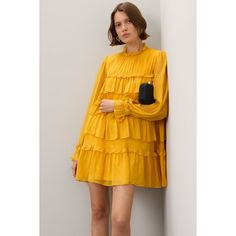 Yellow chiffon (100% Polyester). Shift. Long sleeves. Mock neck. Back button closure. 34.5" from shoulder to hemline. Imported. Chiffon Tiered Dresses For Fall, Tiered Chiffon Dresses For Fall, Tiered Chiffon Fall Dresses, Chic Long Sleeve Chiffon Dress With Ruffles, Chic Flowy Chiffon Dress With Ruffles, Chic Knee-length Chiffon Dress, Feminine Long Sleeve Ruffled Chiffon Dress, Feminine Long Sleeve Chiffon Dress With Ruffles, Long Sleeve Chiffon Cocktail Dress With Ruffles