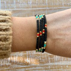 "Black, turquoise, red, white and gold beaded wrap style bracelet is 28\" long and will wrap around on average wrist (6.5-7\") four times. It comes with 1\" chain extender. It could be worn also as a necklace. Details: - Adjustable wrap style bracelet: 28\" long with 1\" chain extender, full length 29\" designed to fit 6.5-7\" wrists, - Listings include one bracelet - Bracelets may vary in exact pattern. Slight variations due to the individuality of each piece - This item should be kept away fro Spiritual Black Beaded Jewelry For Beach, Spiritual Black Beads Jewelry For Beach, Black Round Beads Jewelry For Beach, Black Heishi Beads Bracelet With Colorful Beads, Black Heishi Beads For Beach, Hand Wrapped Black Beaded Bracelets For Beach, Black Heishi Beads Bracelet As Gift, Beach Jewelry With Black Heishi Beads, Hand Wrapped Black Beach Jewelry