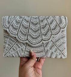 This beautiful Luxurious Pearl Diamond clutch bag is a true masterpiece and timeless accessory that exudes elegance and sophistication. Its delicate luster and classic design make it perfect for formal occasions, such as weddings, red-carpet events, or black-tie galas. The soft sheen of the pearls and sparkly diamonds adds a touch of understated luxury. The bag's interior is just as impressive, with a sturdy lining and ample storage space to hold all your essentials in style. This luxurious hand Affordable Embellished Clutch For Wedding, Luxury Embellished Evening Bag For Formal Occasions, Luxury Timeless Evening Bag For Formal Occasions, Luxury White Embroidered Evening Bag, Classic Luxury Clutch Evening Bag, Luxury Handmade Evening Bag For Formal Events, Luxury Clutch For Formal Occasions, Luxury Hand Embellished Clutch, Luxury Hand-embellished White Bag