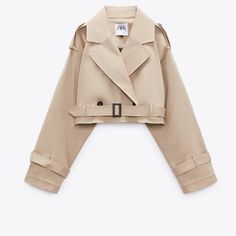 a beige trench coat is hanging on a hanger