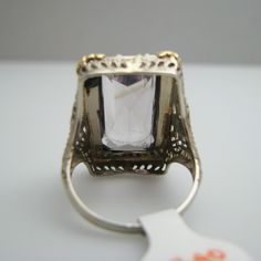 "For sale: (1) d840 14k White Gold Amethyst Seed Pearl Ring PLEASE READ ENTIRE DESCRIPTION BEFORE PURCHASING Pre-owned item. Good condition. Please see pictures for details. Sold as is, as seen on pictures. This ring contains one large amethyst and 41 seed pearls. It is not stamped, but has been tested for authenticity. Specifics: 14k White gold Size: 7 (U.S.) Stone Dimensions: 20 mm x 10 mm Width: 24.3 mm Total Weight: 6.9 grams Please be 100% sure of your purchase before buying, as we do not o Elegant Rectangular Amethyst Ring For Formal Occasions, Rectangular Stone Ring Hallmarked For Anniversary, Hallmarked Rings With Rectangular Stone For Anniversary, Rectangular Stone Hallmarked Rings For Anniversary, Formal 14k Stamped Amethyst Ring, Hallmarked Silver Emerald-cut Gemstones, Classic Octagon Amethyst Ring As A Gift, Classic Octagon Amethyst Ring As Gift, Art Deco Amethyst Ring In Yellow Gold