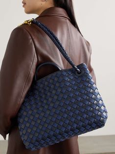 BOTTEGA VENETA Andiamo medium embellished intrecciato leather and denim tote Blue Leather Shoulder Bag With Woven Detail, Blue Woven Leather Bag, Designer Blue Bags With Braided Handles, Luxury Blue Shoulder Bag With Braided Handles, Modern Blue Woven Leather Bag, Chic Blue Bag With Intrecciato Weave, Blue Woven Leather Top Handle Shoulder Bag, Blue Bags With Intrecciato Weave, Blue Woven Leather Shoulder Bag For Shopping