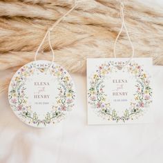 two tags with floral designs hang from twine