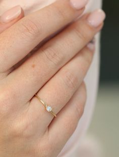 a woman's hand with a diamond ring on it