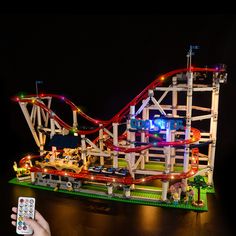 a toy roller coaster lit up at night