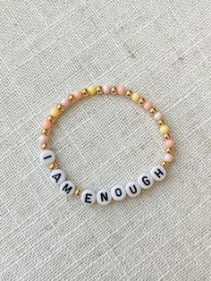 "Mommy and Littles Co affirmations \"I am Enough\" bracelet. Such a small item can make such a big difference! Details: *4mm gumball beads. *acrylic black and white letter beads. *4mm 14k gold plated beads. *Made with jewelry quality elastic. *please message if you are needing a size that is not listed! *NOTE: this listing is for ONE bracelet." Affirmation Beaded Bracelets, Personalized Pink Beaded Bracelet With Meaningful Style, Personalized Pink Beaded Bracelets, Handmade Inspirational Stretch Bracelet As Gift, Handmade Inspirational Stretch Bracelet Gift, Inspirational Handmade Stretch Bracelet As Gift, Inspirational Handmade Stretch Bracelet Gift, Pink Meaningful Bracelets For Friendship, Inspirational Handmade Name Bracelet For Everyday