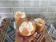 two cups filled with dessert sitting on top of a table