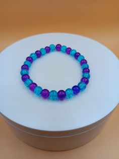 Purple and blue 6mm glass bead bracelet. It is a great gift for a birthday, Christmas, Mother's Day, Valentine's Day or even for yourself. Bracelet is crafted with quality elastic stretch cord for the perfect fit. Bracelet sizes are from 6.5 inches to 8 inches. If your wrist size is not listed then please contact me with your wrist size. I will gladly do a special order.  All items are made to order. They are shipped via United States Postal Service with a tracking number. Items will be shipped Blue Round Bead Bracelet For Birthday, Hypoallergenic Blue Beaded Bracelets For Birthdays, Turquoise Stretch Bracelet With Round Beads As Gift, Faceted Beads Stretch Bracelet Gift, Blue Bracelets With Faceted Beads As A Gift, Hypoallergenic Blue Beaded Bracelets For Birthday, Blue Round Bead Stretch Bracelet For Birthday, Blue Bracelets With Spacer Beads As Gift, Purple Stretch Bracelet With Round Beads As Gift